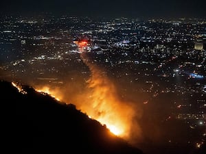 Water is dropped by helicopter on the Sunset Fire