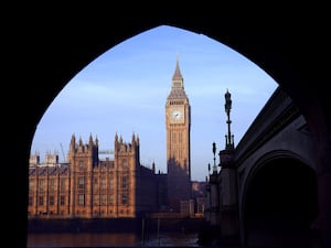 A shot of Big Ben taken from under a bridge arch