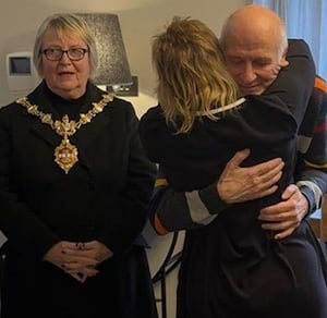 Yvonne hugs her husband Tony as Dudley mayor Cllr Hilary Bils pays tribute to Tony for the help and support provided to Yvonne over the years 