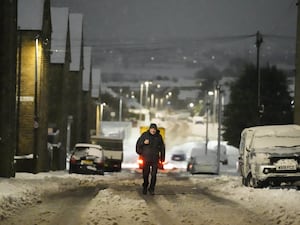 A person walks through snow in Bradford