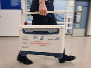 A medic carries an NHS Blood and Transplant box marked 'Human organ in transit'