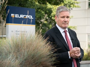 Sir Keir Starmer in front of a Europol sign