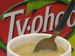 A mug of tea in front of the Typhoo Tea logo