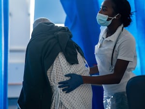 Nurse assisting a patient to move