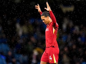 Virgil van Dijk raises both arms to celebrate