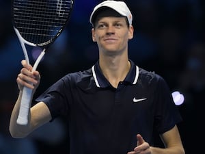 Jannik Sinner smiles after beating Casper Ruud