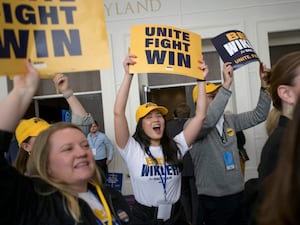 Democrat supporters holding banners reading 'Unite, fight, win'