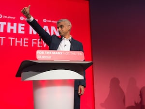 An image of Sadiq Khan with his thumb stretched out on stage at the Labour Party conference in 2017