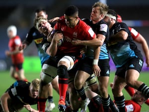 Ulster’s Cormac Izuchukwu, centre, is tackled as he runs with the ball