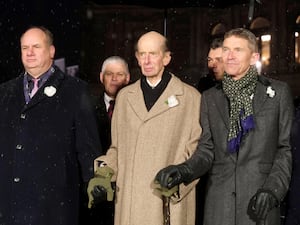 The Duke of Kent holds hands with people as he joins a human chain in remembrance in Dresden