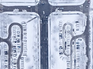 An aerial view of traffic and parked cars during heavy snowfall in Sarajevo, Bosnia