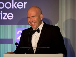 A man in a black dinner jacket