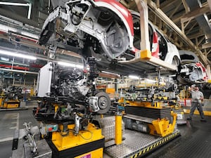 Workers on the production line at a car factory