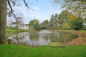 The manor buildings sit in nearly four acres of elegantly landscaped grounds featuring mature ponds and a circular fishpond that dates back to Victorian times.