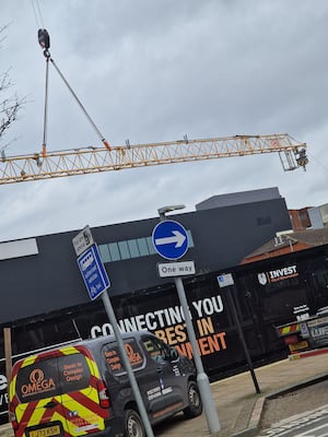 Workmen demolished a large crane between Cleveland Street and Bell Street on Monday