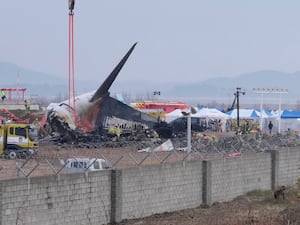 Rescue team members work at the site of a plane crash at an airport