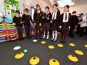 Pupils in a computing lesson learning how to control an object using computer programming 