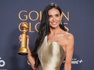 Demi Moore poses with the Golden Globes award for best performance by a female actor in a motion picture – musical or comedy for The Substance