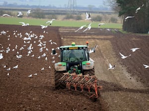 A farmer ploughs a field in North Yorkshire