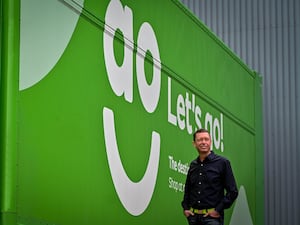 AO founder and chief executive John Roberts standing in front of an AO World delivery van