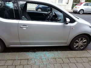 Smashed side window of parked car