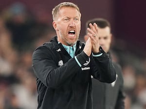 Graham Potter shouts and claps on the touchline