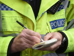 Police officer writing in his notepad