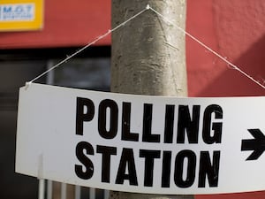 A sign pointing to a polling station