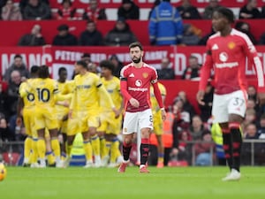 Bruno Fernandes (centre) stands dejected as Crystal Palace players celebrate in the background