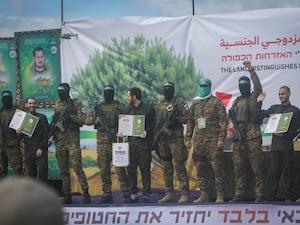 Israeli hostages, from left to right, Eliya Cohen, Omer Shem and Omer Wenkert, surrounded by Hamas fighters