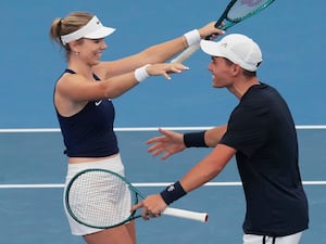 Katie Boulter and Charles Broom go to hug in celebration