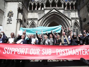 Former post office workers celebrate outside the Royal Courts of Justice