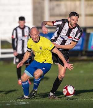 Captain Michael McGrath challenges for the ball. Pic: Jim Wall