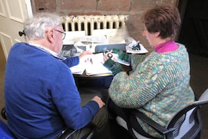 Volunteers Tony and Caroline reviewing the Joan Crooke Archive. 