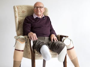 Roy Hayward sitting on a chair