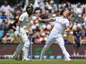 Ben Stokes (right) bowls for England