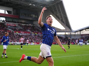 Liam Delap raises his arm as he celebrates scoring a goal