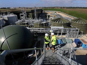 Two workers talk on a wastewater treatment plant