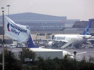 An aeroplane at a gate at Manchester Airport