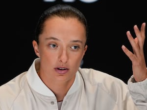 Iga Swiatek gestures during a press conference