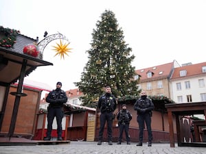 Policemen patrol a Christmas market