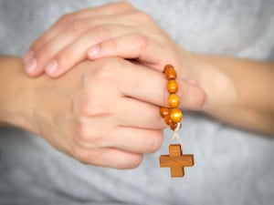 Hands with rosary beads