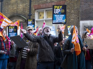 Sixth form college teachers wave flags