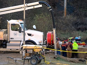 Workers probing a sinkhole