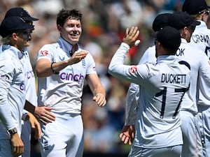 England bowler Matthew Potts, centre, is congratulated by teammates after taking the wicket of New Zealand’s Tom Latham