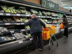 Shoppers in the fruit and vegetables section of a supermarket