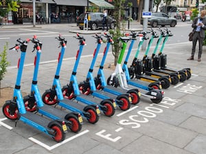 A row of e-scooters for hire in the Kensington area of London