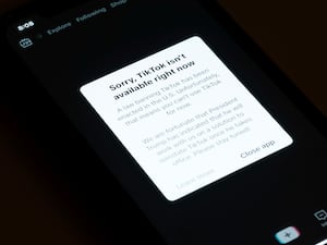 A message reading 'Sorry, TikTok isn’t available right now' is displayed from the TikTok app on a mobile phone screen in Los Angeles