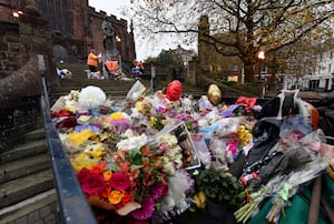 Dozens of bouquets of flowers and other tributes were moved from outside St Peter's Collegiate Church 