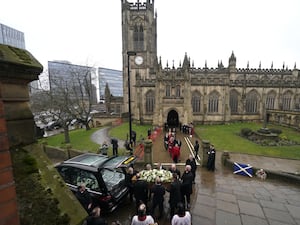 Denis Law's coffin is carried out of Manchester Cathedral following his funeral